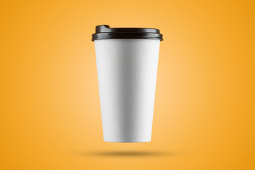 Paper white coffee cup isolated on a yellow background. mockup, layout, copy space