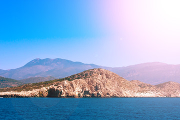 View of calm Mediterranean sea with  mountain on bright sunlight, Seascape with montains and blue water