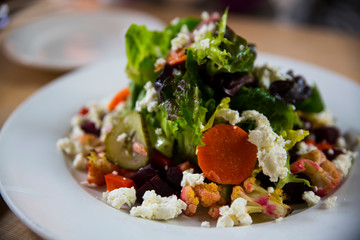 Victoria, British Columbia, Vancouver Island, Canada. Fresh green leaf salad with beets, carrots, cucumber and marinated cauliflower