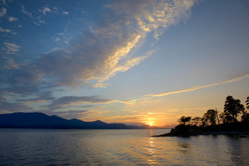 Canada, British Columbia, Gulf Islands, Tent Island. Sunset over Vancouver Island with clouds