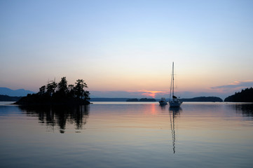 Naklejka na ściany i meble Canada, British Columbia, Gulf Islands, Wallace Island. Boats anchored on a calm ocean at sunset