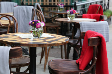Street cafe, empty tables with menu in a restaurant outdoor, elegant setting for celebration and...