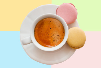 White cup of espresso coffee with colourful french macarons top view on colorful background, Good morning or have a nice day message concept background.