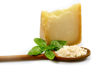 piece of cheese or Italian cheese with fresh green basil isolated on white background with clipping path.