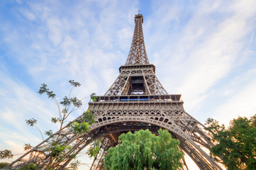 Beautiful Eiffel tower in summer Paris, France under the blue sky white cloud, Eiffel Tower, the most romantic tourist attraction and the symbol of Paris.