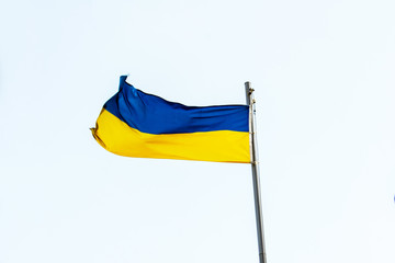 Ukrainian flag, waving flag of Ukraine, close up, blue sky