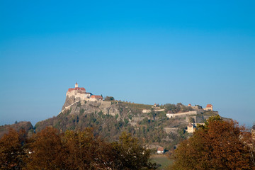 Austria - Low angle view of a village built on a mountaintop. Horizontal shot