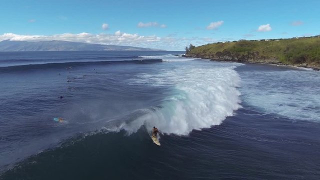 Aerial shot of sufers in Hawaii 