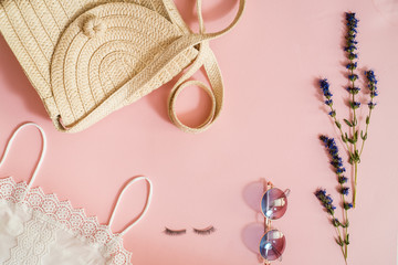 Beauty products, everyday make-up vibrant background. Cosmetic essentials - eyelashes, eyeshadow, lipstick and nail polish on blue, flat lay, top view