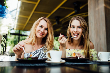 Photo of young positive dougter and mom eating chocolate fondant. Spend time happy. Morning breakfast sweets. Lifestyle.