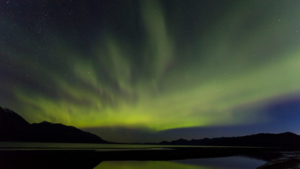 Canada, Yukon Territory, Kluane Lake. Aurora borealis reflects in lake. Credit as: Don Paulson / Jaynes Gallery / DanitaDelimont.com