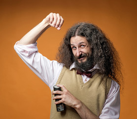Freaky nerd using a fragrant deodorant