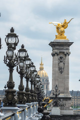 Fototapeta na wymiar Golden statue on Pont Alexandre III, Paris, France, Europe