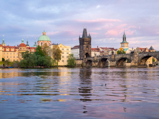 Fototapeta na wymiar Czech Republic, Prague. View of the Lesser town bridge tower and clock tower on the Vltava river.