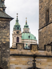 Obraz premium Czech Republic, Prague. St Nicholas Church dome above orange roof tops of Mala Strana.