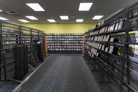 Empty shelves inside of a Blockbuster Video store in its final days of liquidation sale