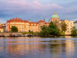 Obraz premium Czech Republic, Prague. Dusk on the Vltava river with the buildings of Lesser Town and the dome of St. Nicholas Cathedral.