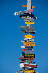 Falkland Island, Stanley (aka Port Stanley). Stanley Totem Pole, colorful directional signs to...
