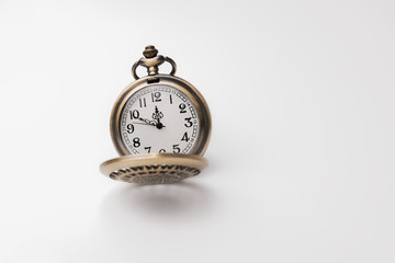 Old pocket watch closeup isolated on white background