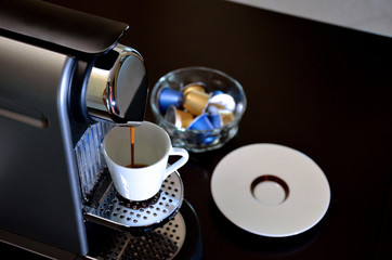 Espresso machine in action, filling a good cup of coffee.