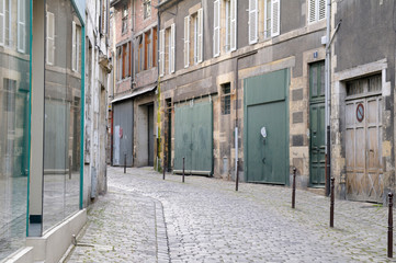 France, Burgundy, Nievre, Nevers. Narrow street with closed stores