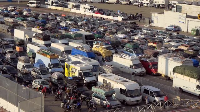 Many Cars Loaded With All Sorts Of Things Waiting In Front Of The Border