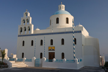 Greece, Santorini, Thira, Oia. Large Greek Orthodox church in main square with dome and bell tower.