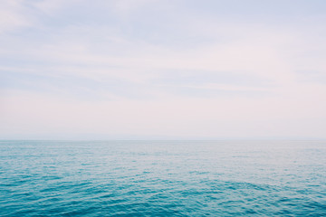 Fototapeta na wymiar Blue sea and fair shiny sky background.