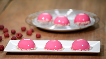 Mousse cake with pink mirror glaze. Raspberry Mousse Cakes