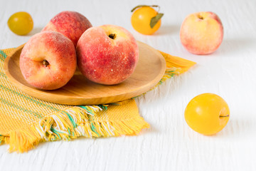 Peaches on white wooden background