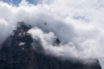 Alpine peak with beautiful white clouds