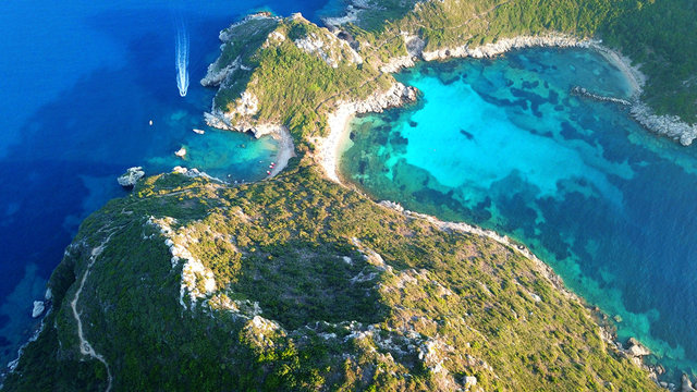 Aerial drone photo of iconic paradise bay of Porto Timoni with tropical deep blue and turquoise clear sea, Corfu island, Ionian, Greece