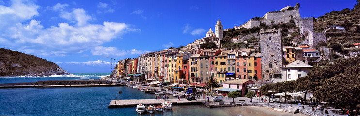 Fototapeta na wymiar Italy, Portovenere. The brightly-painted buildings of Portovenere, a World Heritage Site, look over the waters of the Mediterranean Sea, in Liguria, Italy.