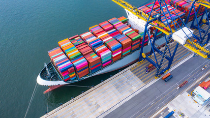 Container ship loading and unloading in deep sea port, Aerial top view of business logistic import...