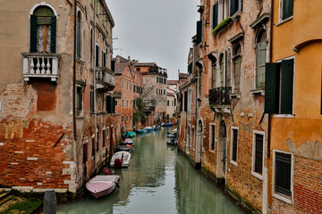 Fototapeta na wymiar Canal and Bridges with boats Venice Italy