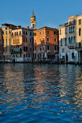 Fototapeta na wymiar Evening light on Grand Canal and its reflection of old buildings and belltower, Venice Italy