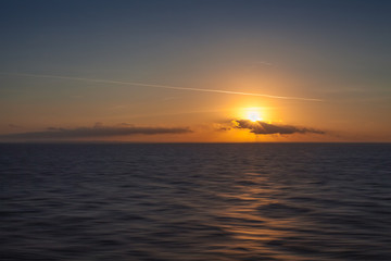 Sunset on the sea with italian coastline background