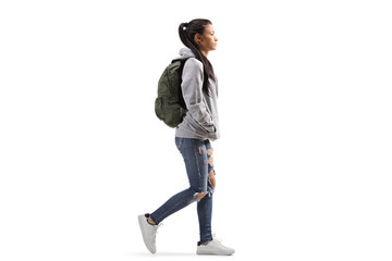 Naklejka premium Female student wearing a hoodie and ripped jeans walking