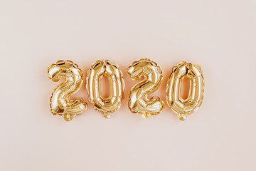 Foil balloons in the form of numbers 2020. New year celebration. Gold and silver Air Balloons. Holiday party decoration.