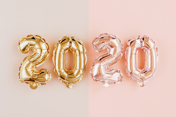 Foil balloons in the form of numbers 2020. New year celebration. Gold and silver Air Balloons. Holiday party decoration.