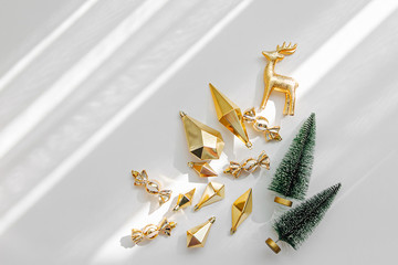 Christmas decorations  and gifts  in gold colors on white background with empty copy space for text. Holiday concept. Flat lay, top view