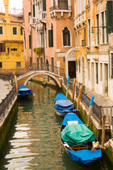 Fototapeta na wymiar Small canal and bridge in Venice, Italy