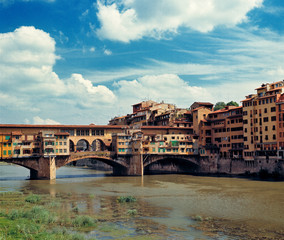 Naklejka premium Italy, Florence. The Ponte Vecchio stretches across the Arno River in Florence, a World Heritage Site, Italy.