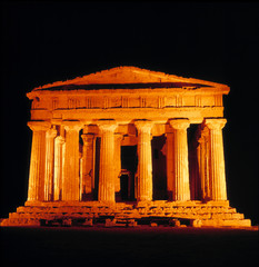 Fototapeta premium Italy, Sicily, Agrigento. Flood-lights emphasize the classic lines of the Temple of Concord at Agrigento, a World Heritage Site, on Sicily, Italy.