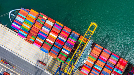 Container ship loading and unloading in deep sea port, Aerial top view of business logistic import...
