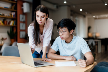 man and woman work in the office with laptop