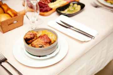 serving of cooked beef with potatoes and carrots