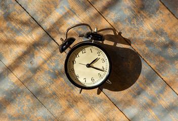 alarm clock on a wooden floor