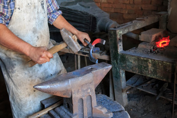 Romania, Transylvania, Carpathian Mountains, Viscri. Blacksmith, horse-shoeing, tools of the trade.