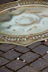 Russia, Moscow, Red Square. Bronze compass that marks the symbolic zero point from which all roads in Russia are measured, good luck coins.